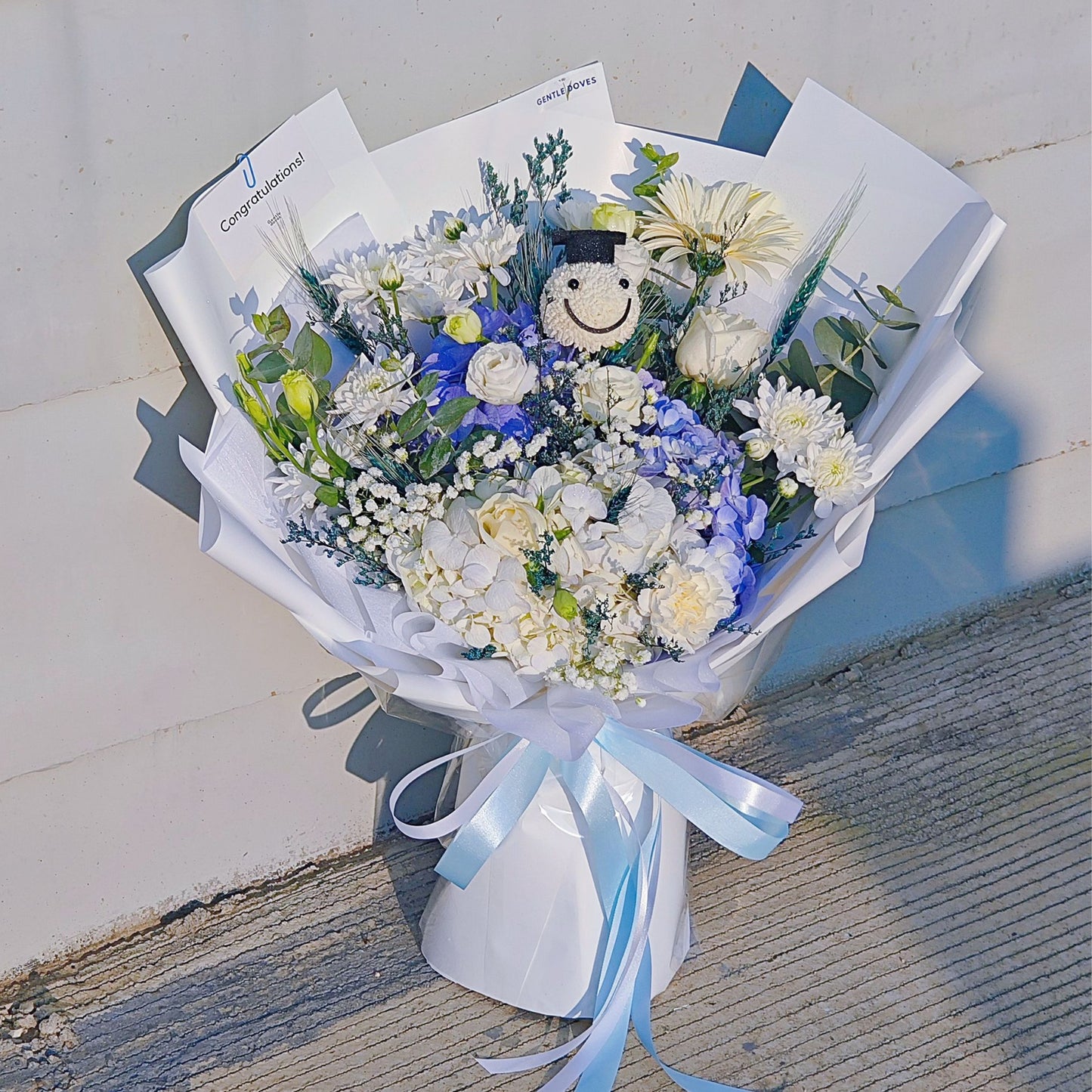 Assorted White and Blue Flowers with Graduated Smiley Face Bouquet