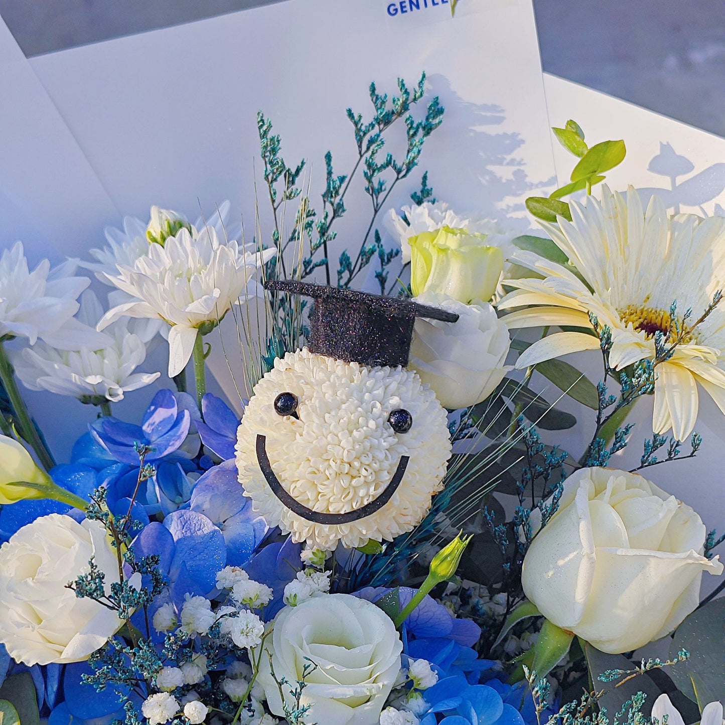 Assorted White and Blue Flowers with Graduated Smiley Face Bouquet