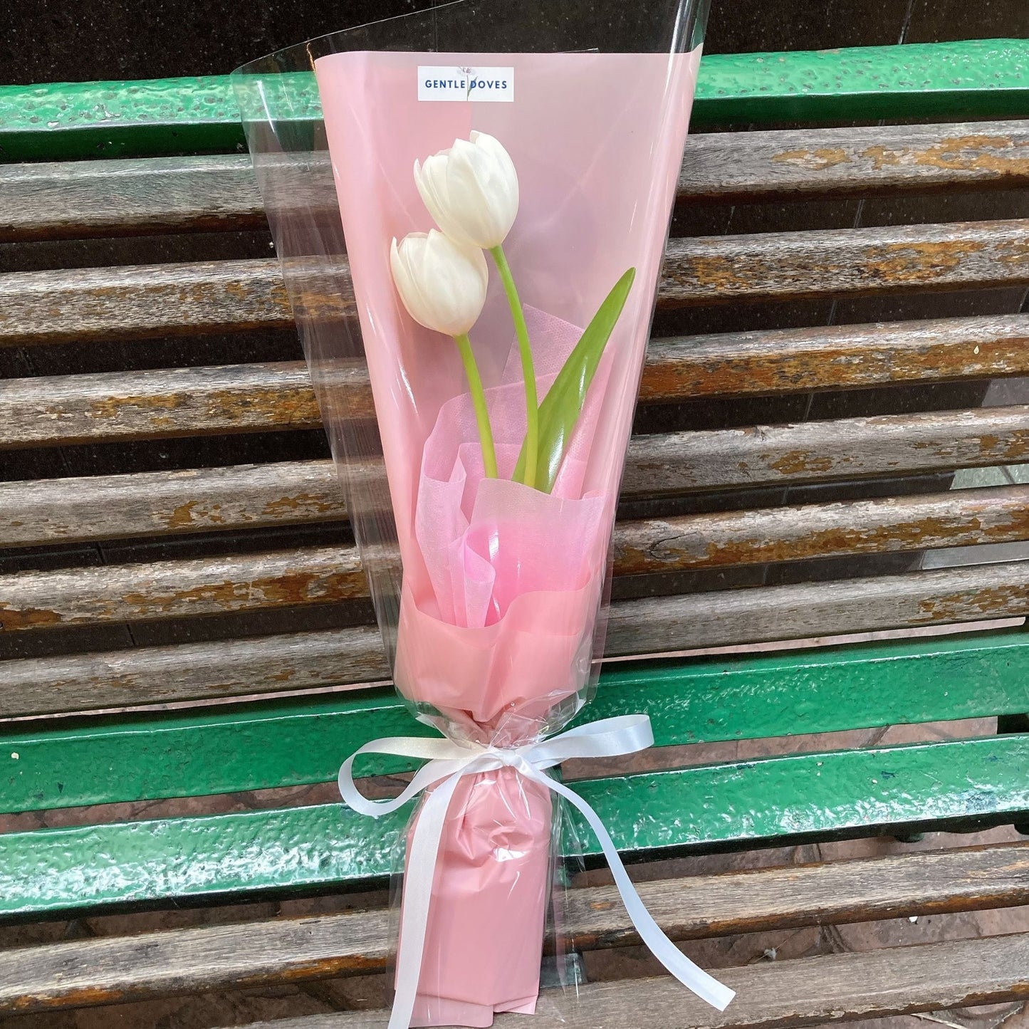 Two White Tulips in Pink Paper Bouquet