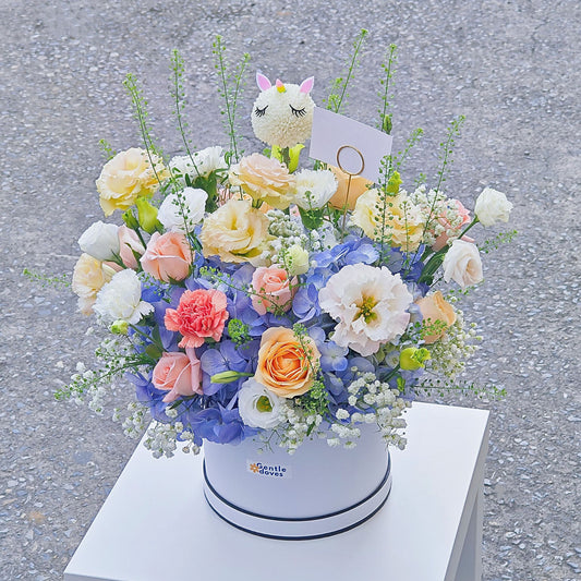 Soft Blue Hydrangea with Soft Color Flowers with Sleeping Unicorn in Medium Box Arrangement