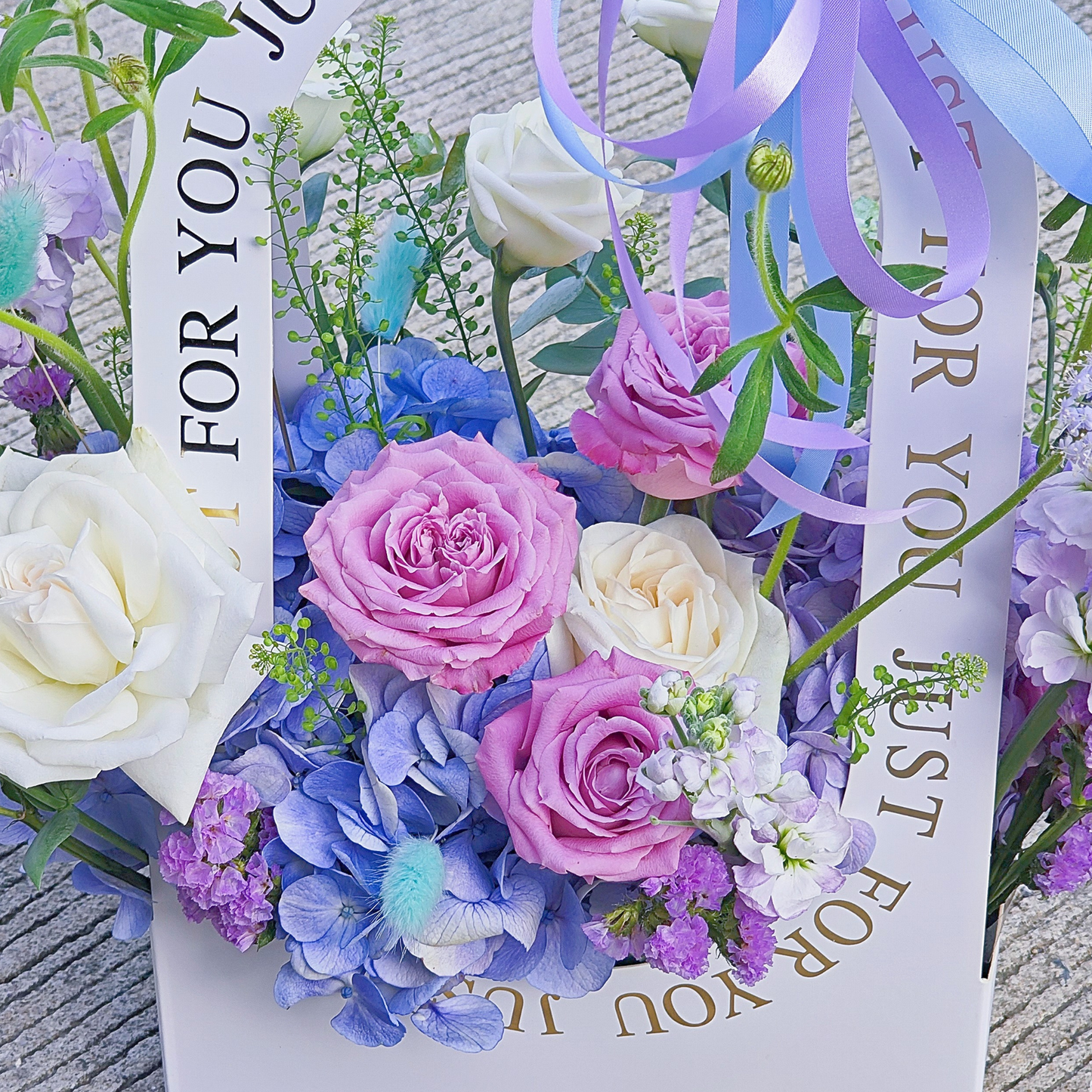 Assorted Soft Purple, Blue and White Flowers in Medium Carrying Flower Box