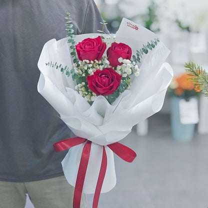 Three Red Roses with Gypsophila and Eucalyptus in White Paper Bouquet