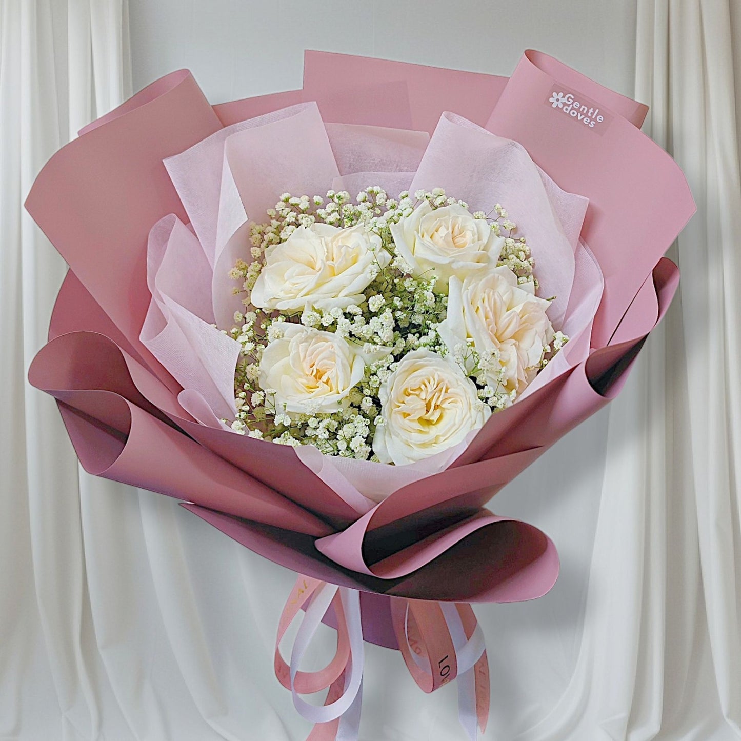 Five White English Roses with Gypsophila in Pink Paper Bouquet