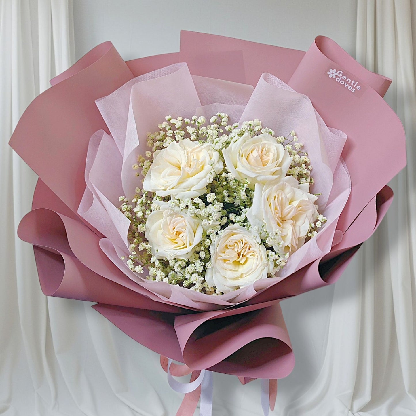 Five White English Roses with Gypsophila in Pink Paper Bouquet