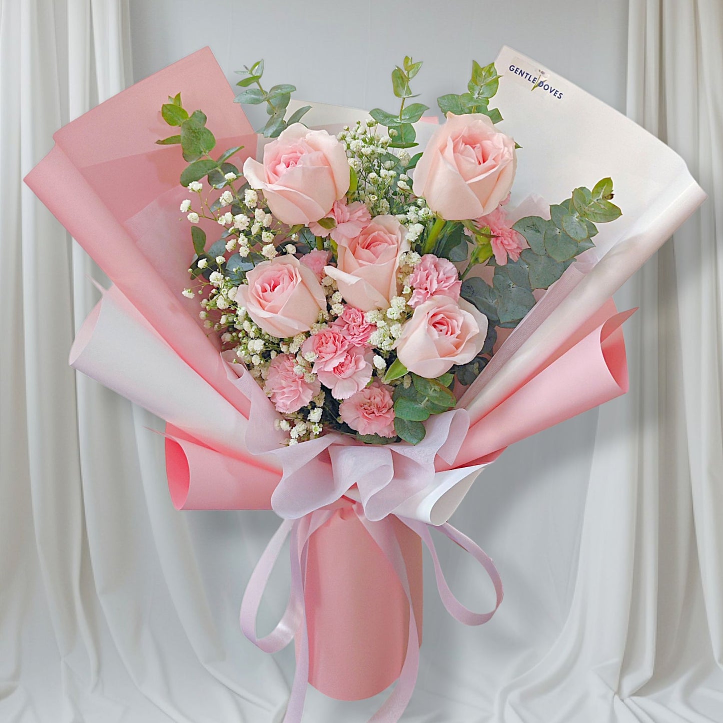 Five Soft Pink Roses with Pink Sprayed Carnations and Foliage Bouquet