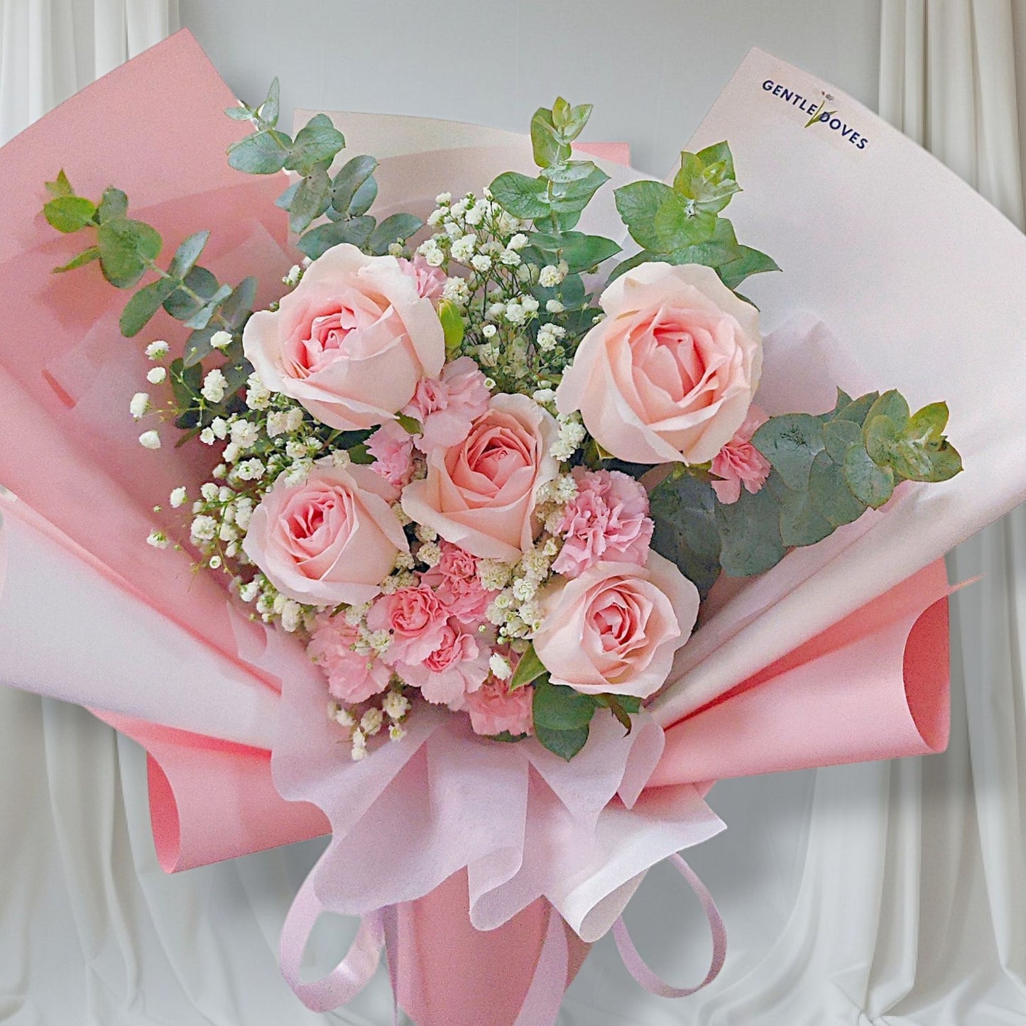 Five Soft Pink Roses with Pink Sprayed Carnations and Foliage Bouquet