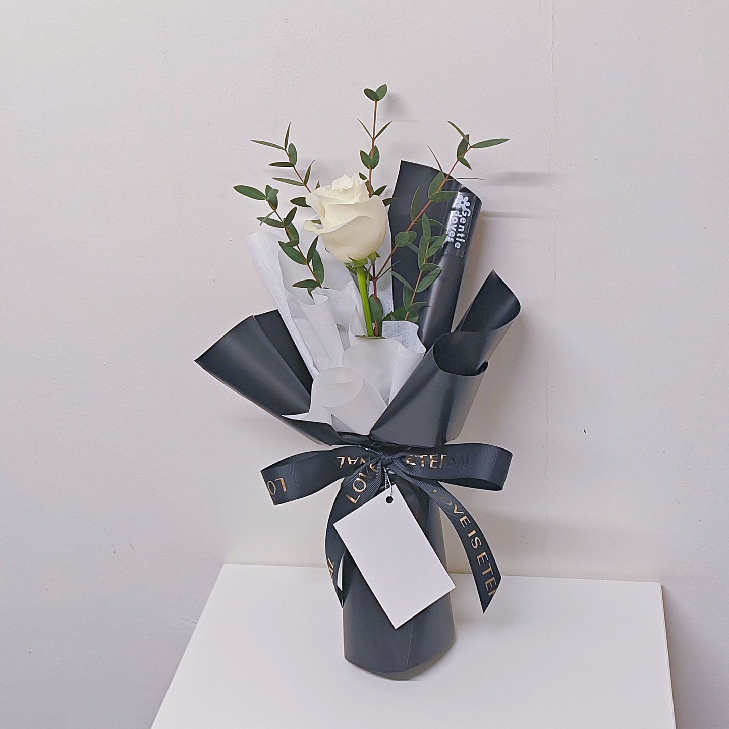 Single White Rose with Eucalyptus in Black and White Paper Mini Bouquet