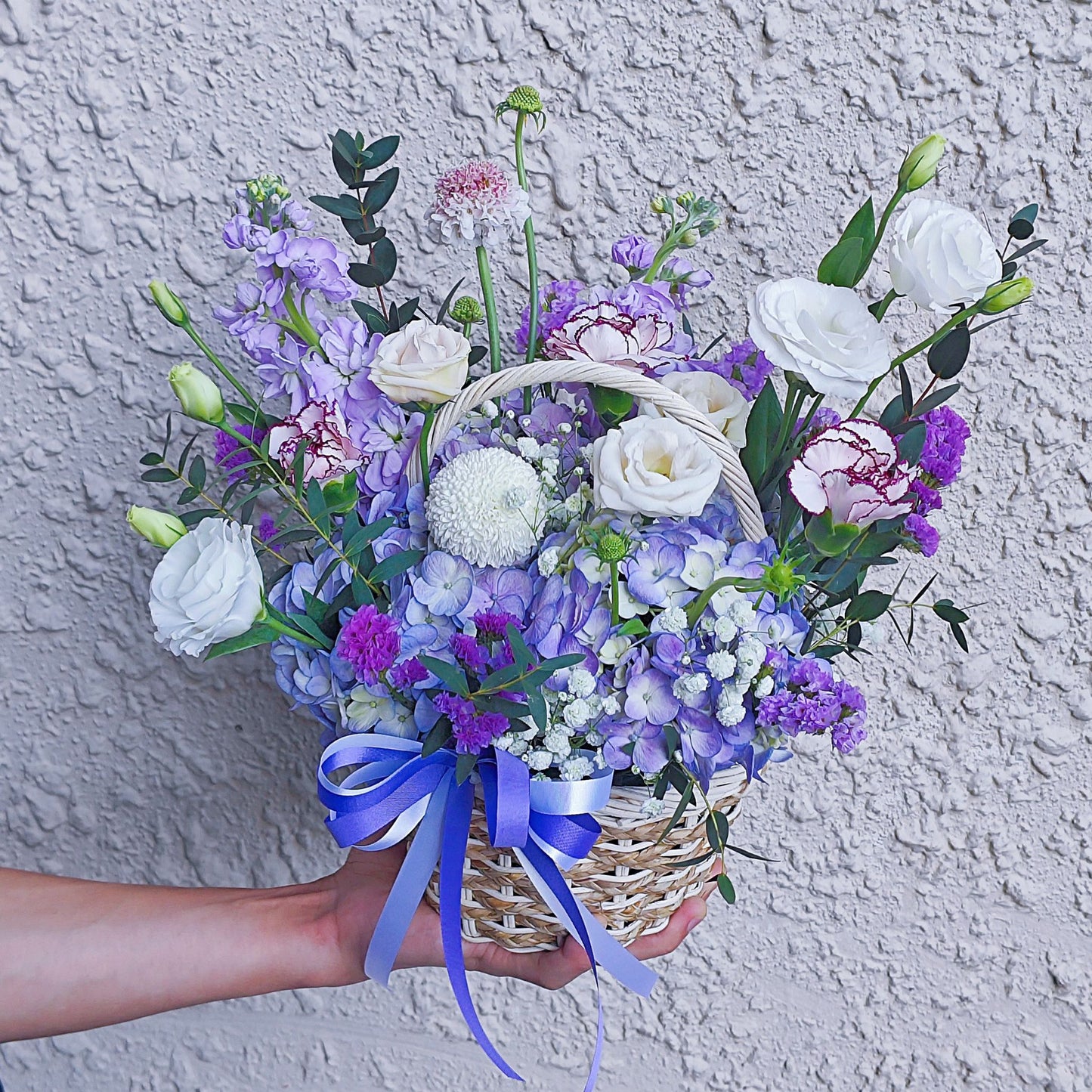 Assorted Purple Flowers in Small Basket Arrangement