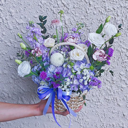 Assorted Purple Flowers in Small Basket Arrangement