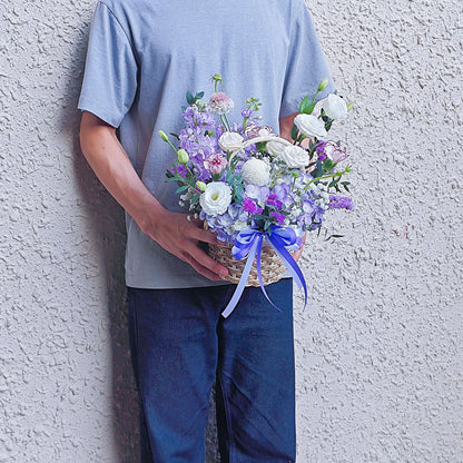 Assorted Purple Flowers in Small Basket Arrangement