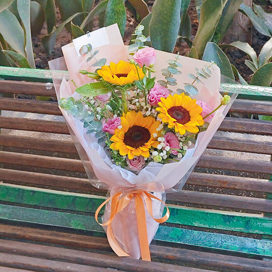 Three Sunflowers with Pink Lisianthus and Green Foliage Bouquet