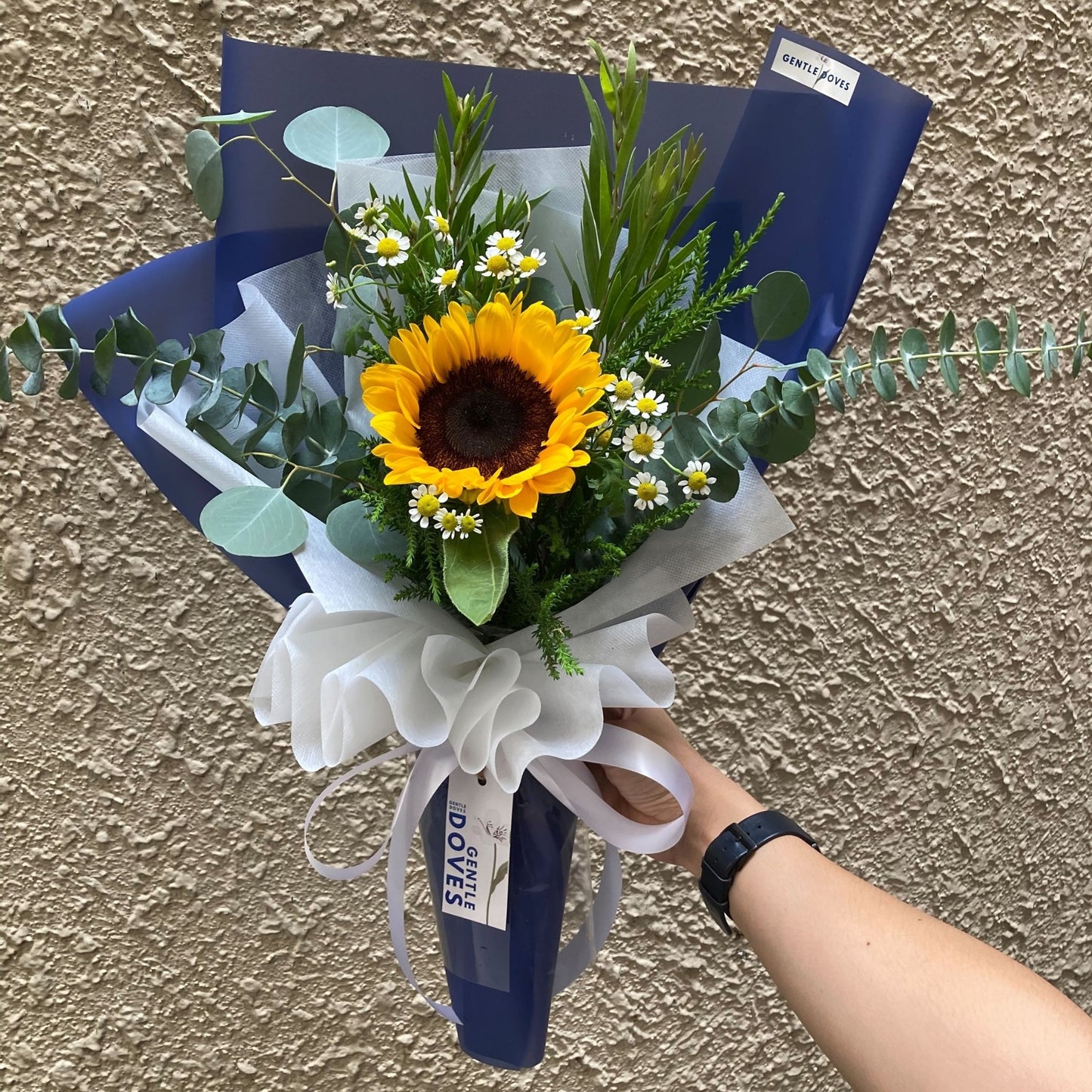 Single Sunflower with Daisies and Foliage in Blue Paper Bouquet