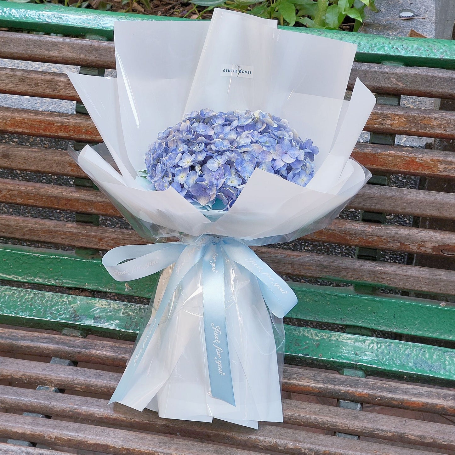 Two Blue Hydrangeas in White Paper Bouquet