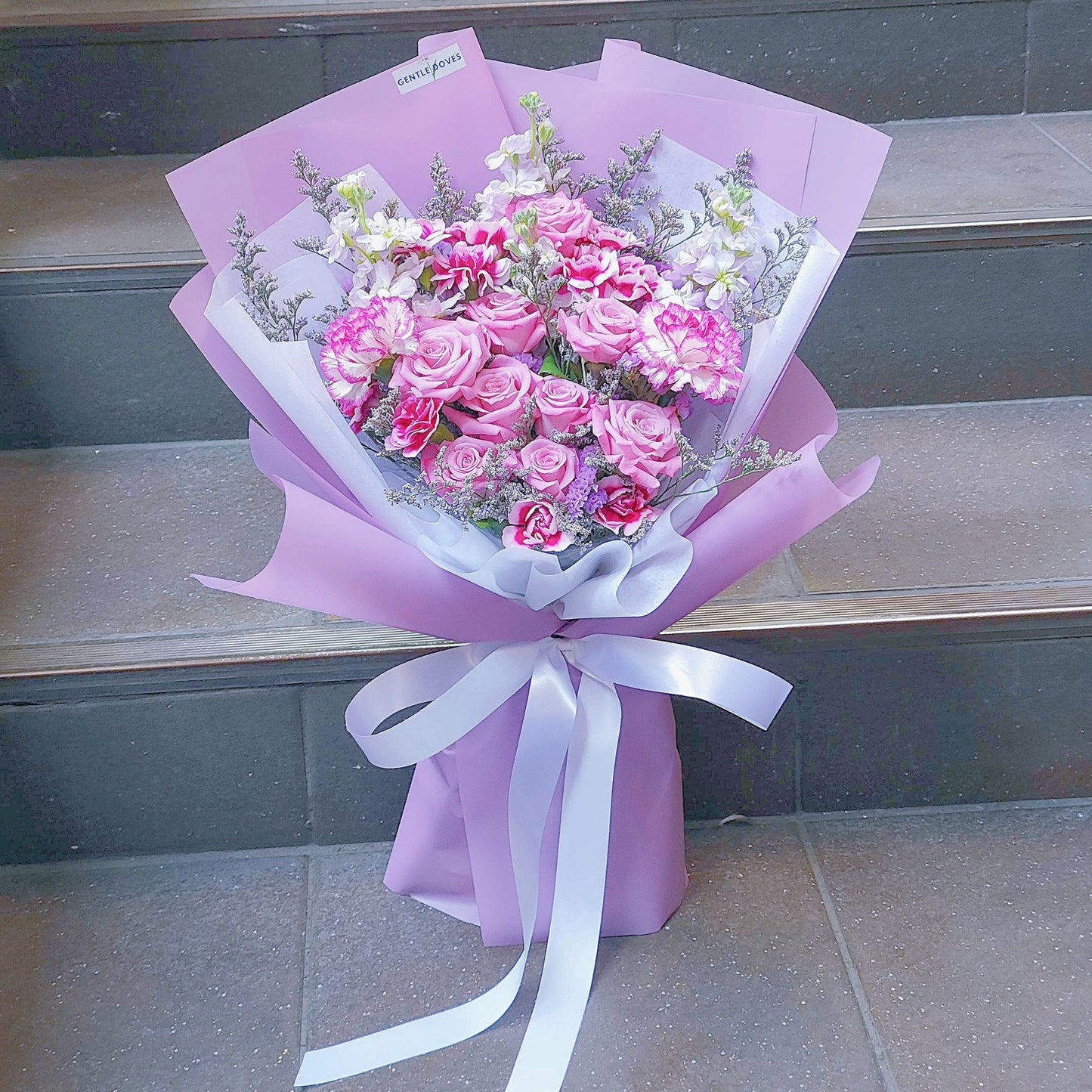 Assorted Purple Flowers in Soft Purple Paper Bouquet