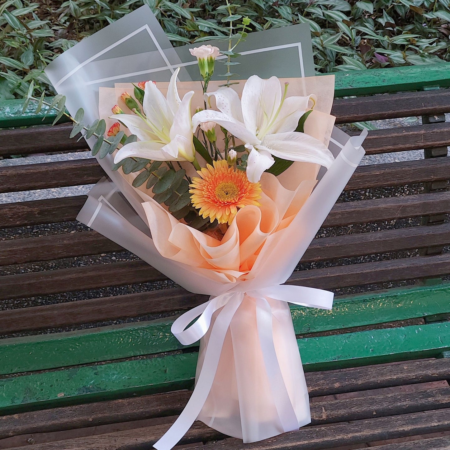 Two Lilies with Assorted Orange Flowers Bouquet