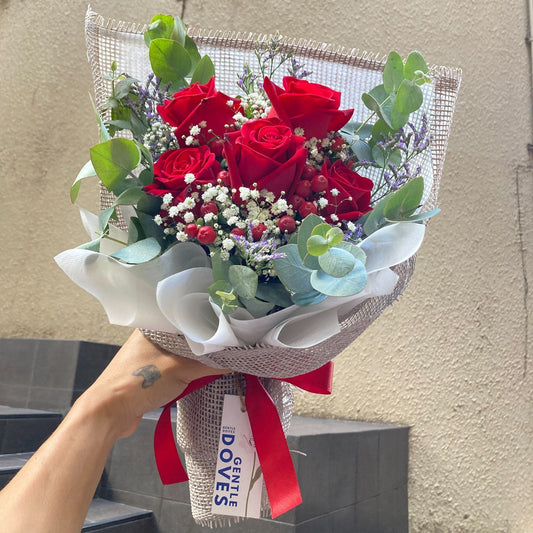 Five Red Roses with Red berries and Foliage Bouquet