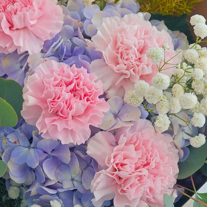 Soft Purple Hydrangeas with Soft Pink Carnations and Green Foliage in Kraft paper Bouquet
