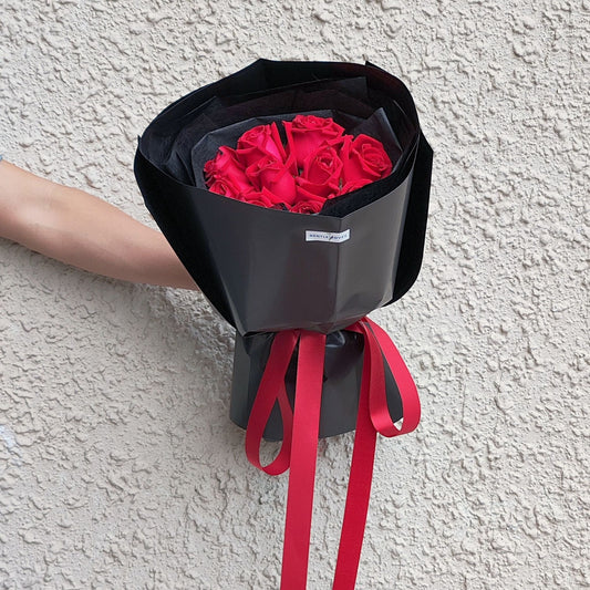 Ten Red Roses in Black Paper Bouquet