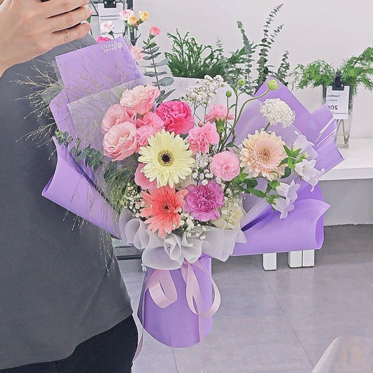 Assorted Soft Tone Flowers in Purple Paper Medium Bouquet