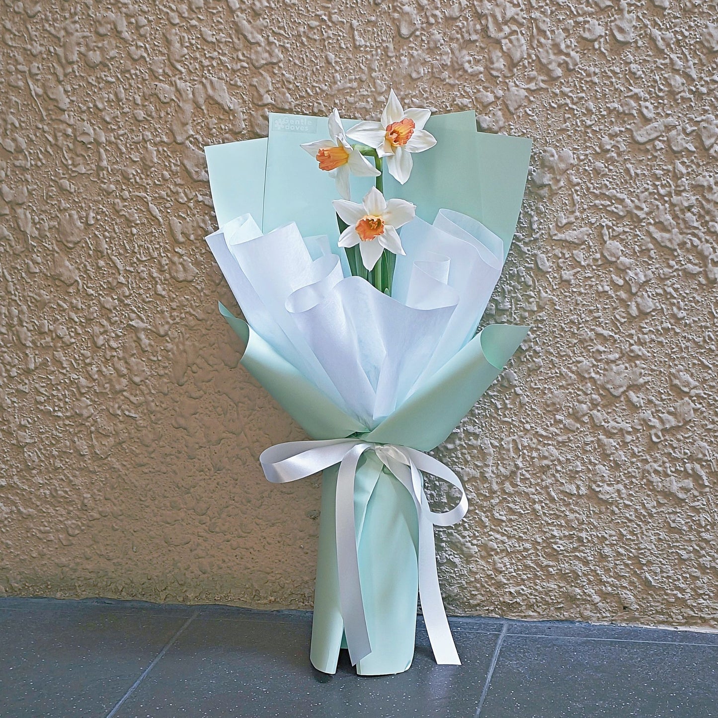 Three Accent Daffodils in Pastel Green Paper Bouquet