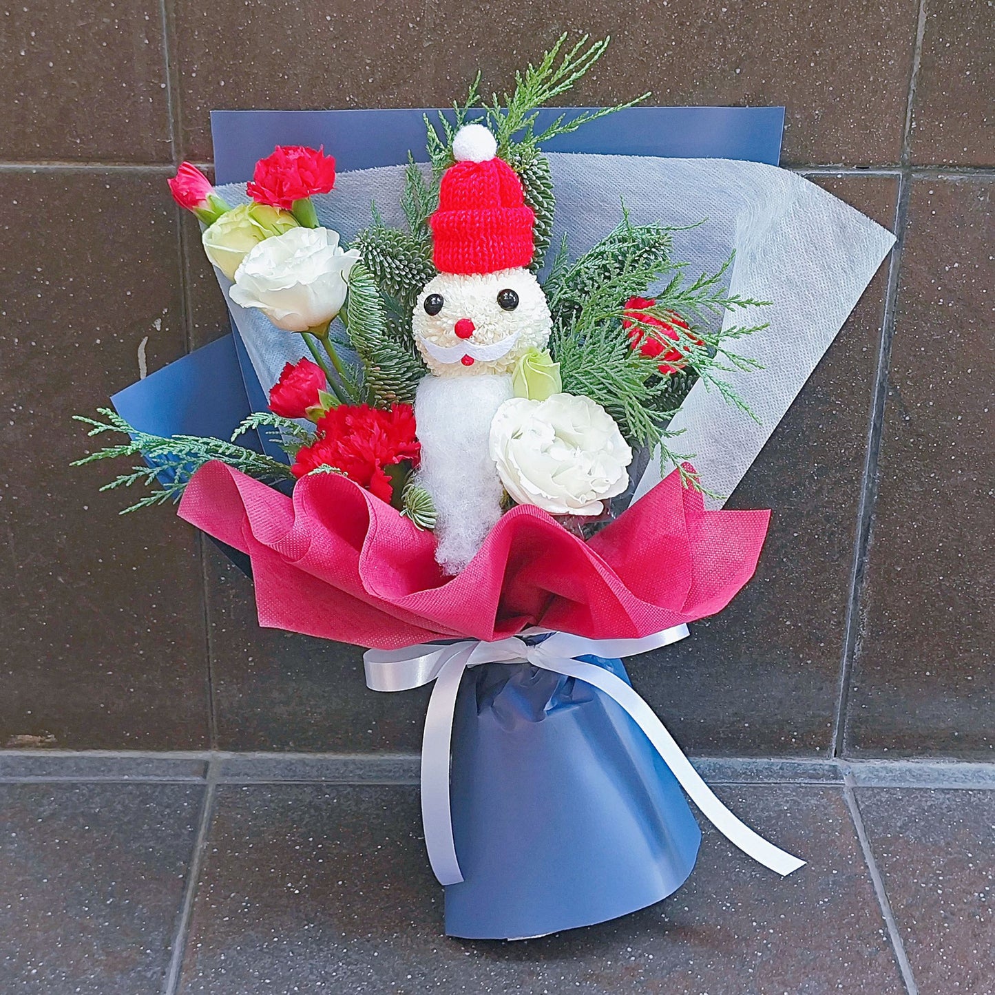 Santa with Red and White Flowers in Blue and Red Paper Bouquet