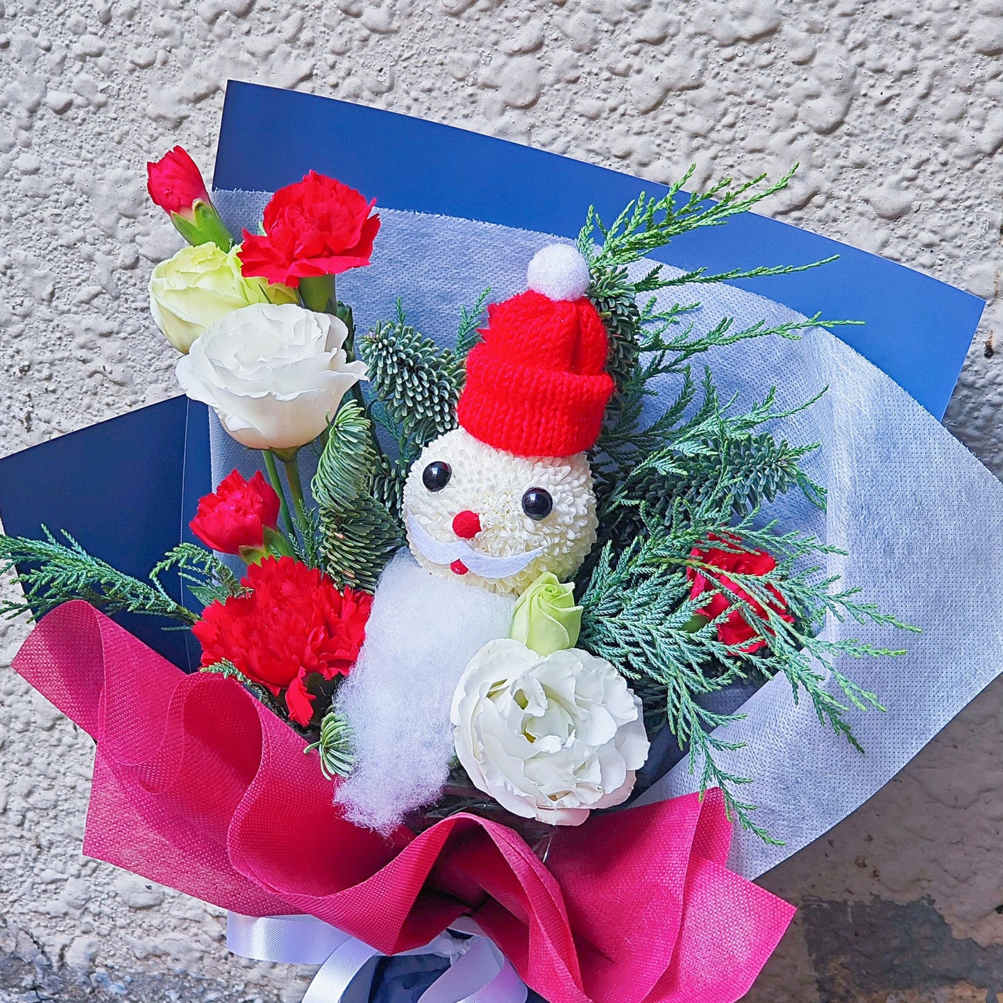 Santa with Red and White Flowers in Blue and Red Paper Bouquet