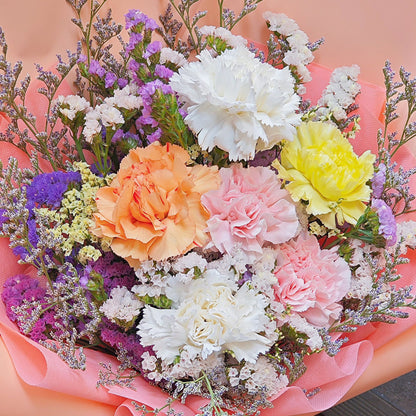 Five Assorted Carnations with Filler Flowers in Soft Peach Paper Bouquet