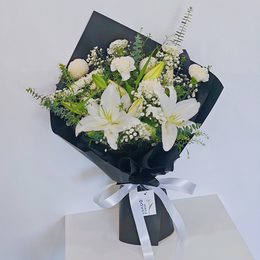 White Lilies with White Flowers and Foliage in Black Paper Bouquet