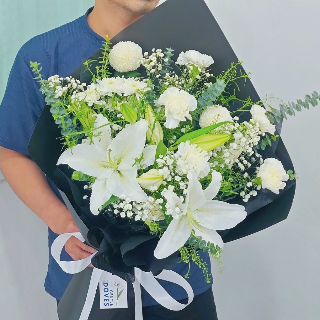 White Lilies with White Flowers and Foliage in Black Paper Bouquet